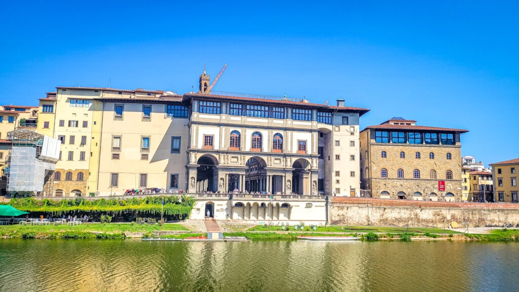 View of Uffizi Gallery from across the river Arno in Florence, Italy. Monumental highlights to visit in Florence, Italy. In the worlds jungle travel.