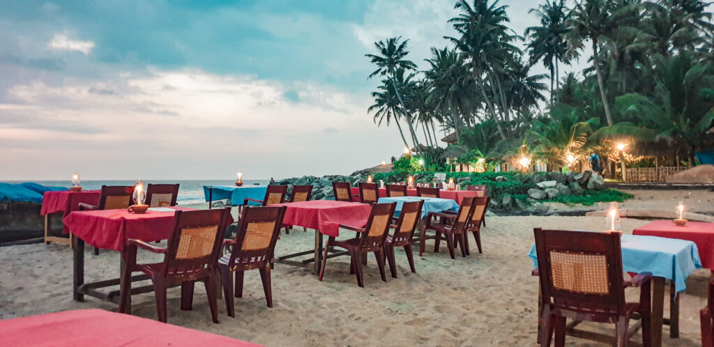 Restaurant at the beach in Varkala. Beginners guide to travel India by train. In the worlds jungle. 