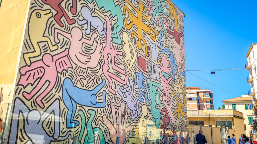Tuttomondo mural painting made by the famous artist Keith Haring in Pisa. Monumental highlights to visit in Pisa. In the worlds jungle.