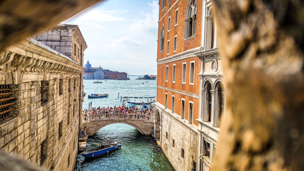View of the canals from Ponte dei Sospiri or the Bridge of Sighs in Venice. Monumental highlights to visit in Venice, Italy. In the worlds jungle. 
