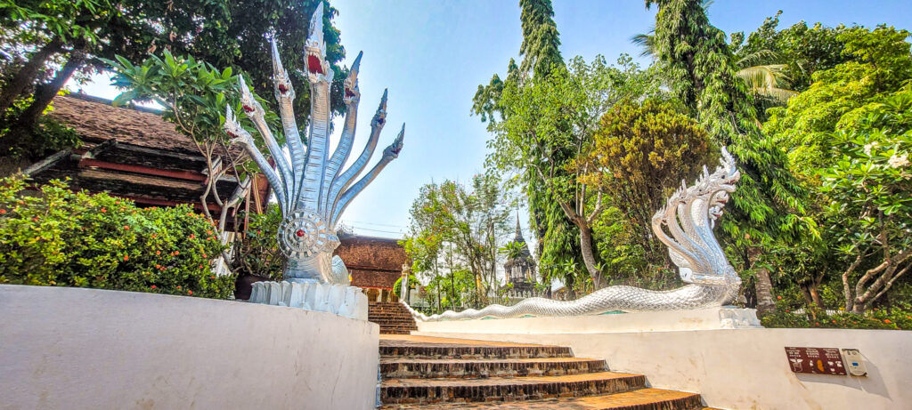 Naga images at the entrance of a temple in Luang Prabang. How to book train tickets as a foreigner in Laos?