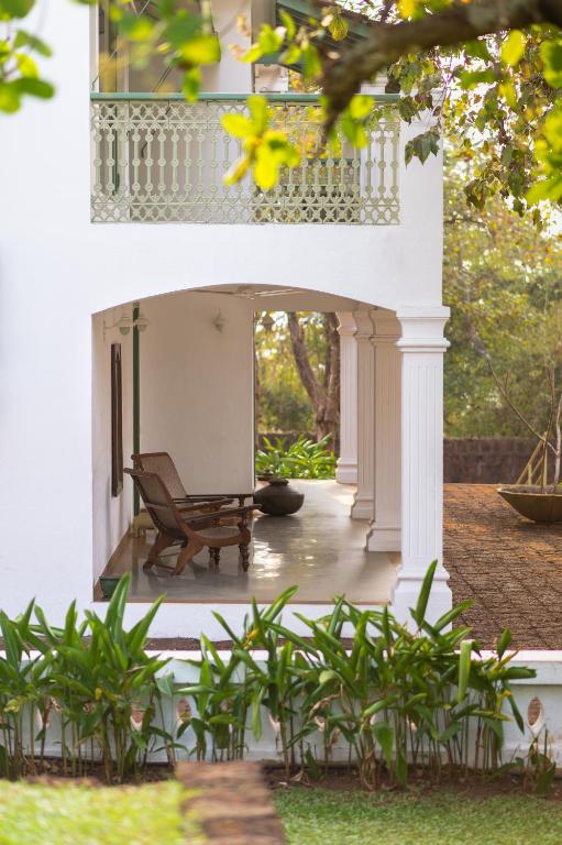 Outside terrace and green garden at The Postcard Velha. Best luxury hotels & resorts in North Goa rated 8.5+ for an unforgettable getaway.