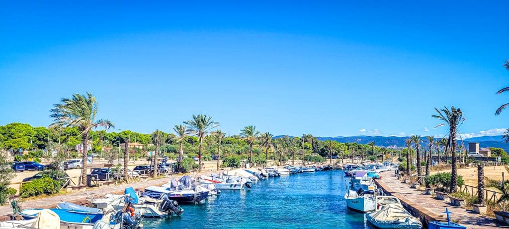 The crystal waters and boats at Porto Pino harbour.