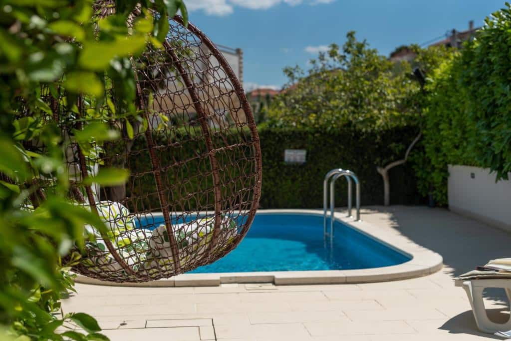 Swimming pool at Apartments Orlic. Trogir & Čiovo Island: history, beaches, culture & coastal beauty
