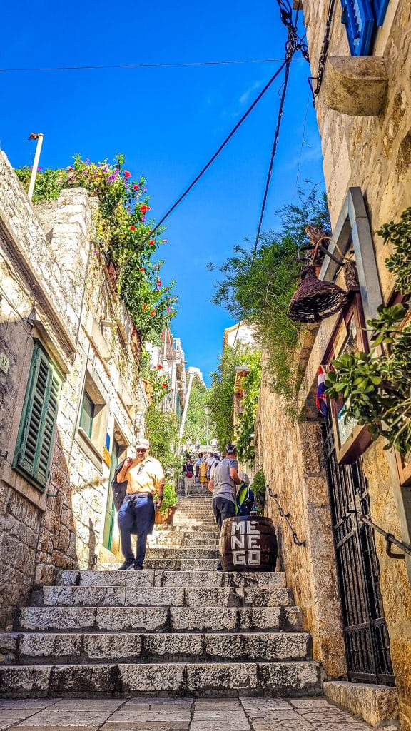 Blooming flowers in an alley in Hvar old town. Hvar Island Itinerary: top sights, beaches, and hidden gems