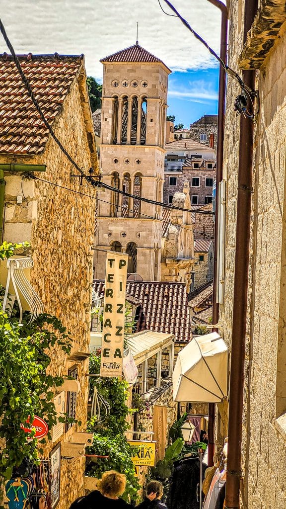 Cozy alley and view of the tower of the Saint Stephen's church. Hvar Island Itinerary: top sights, beaches, and hidden gems