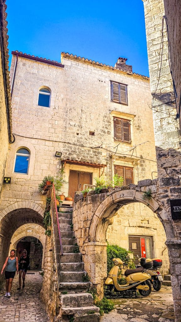 Ancient gate in an alley in the old town of Trogir. Trogir & Čiovo Island: history, beaches, culture & coastal beauty