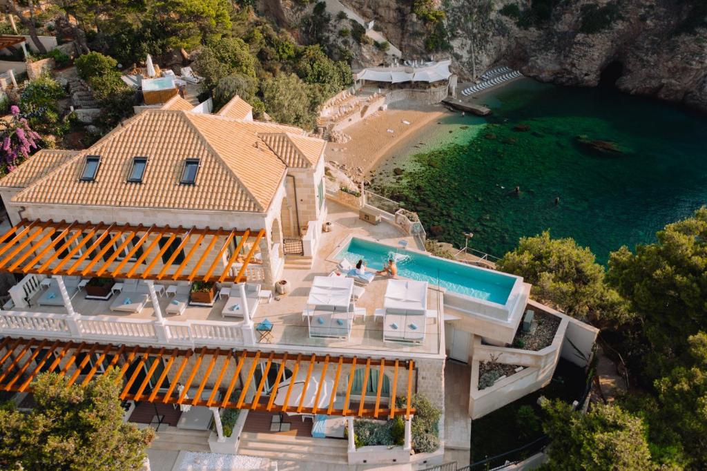 Bird's eye view of the villa, pool, ocean and beach at Villa Orabelle in Dubrovnik.
