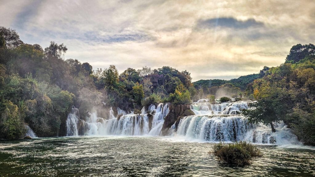 Skradinski Buk with orange clouds. Krka National Park, Croatia: Complete Visitor Guide to Waterfalls, Trails, and Tickets