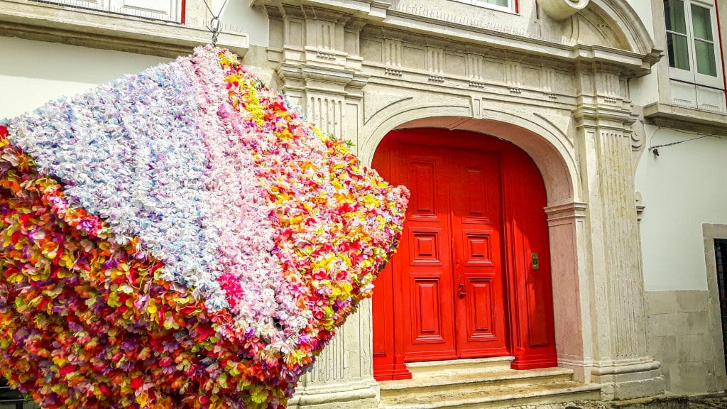 Red door and art statue. Lisbon Travel Guide: what to see, do, and know before you go