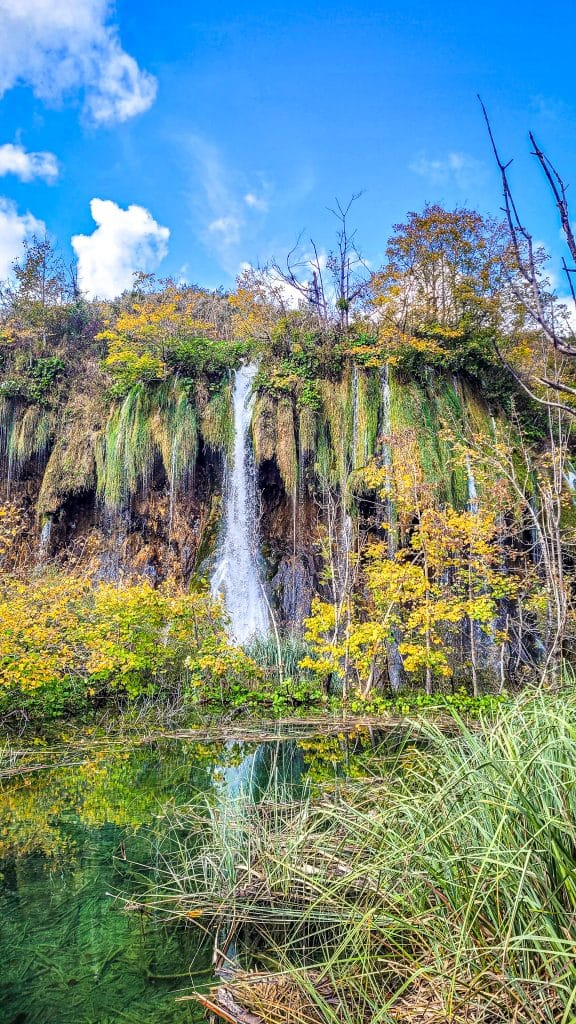 Waterfall and clear green water. Visiting Plitvice Lakes: tips, highlights, and where to stay