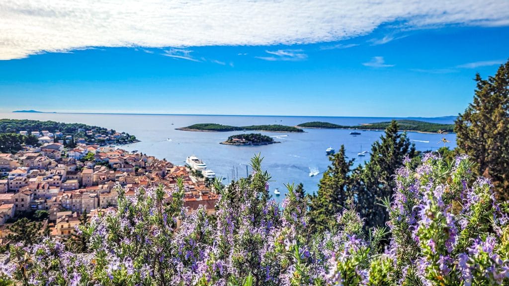 Purple flowers and sceni cview of the islands and ocean at Hvar Island in Croatia. Europe solo travel for women: top 20 questions answered