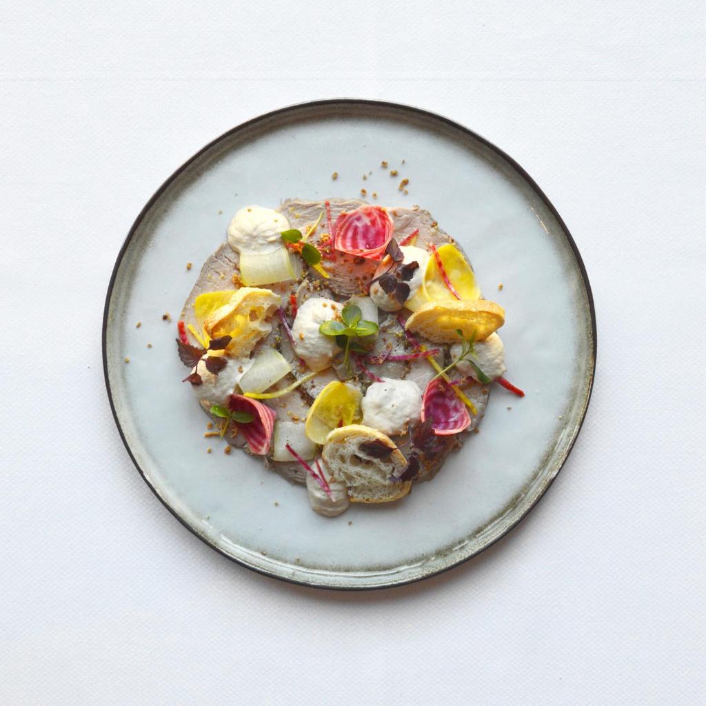 Food platter with a pink and yellow coloured food. Hotel de la Poste - Relais de Napoleon III. Hiking Le Tombeau du Géant in Botassart, Belgium: Trails, tips & local legends