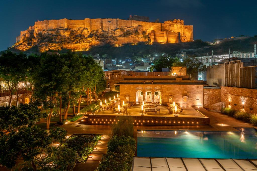 Amazing view of the swimming pool and Mehrangarh Fort at night at RAAS Jodhpur. Rajasthan photography tips: best photo spots & stunning prints