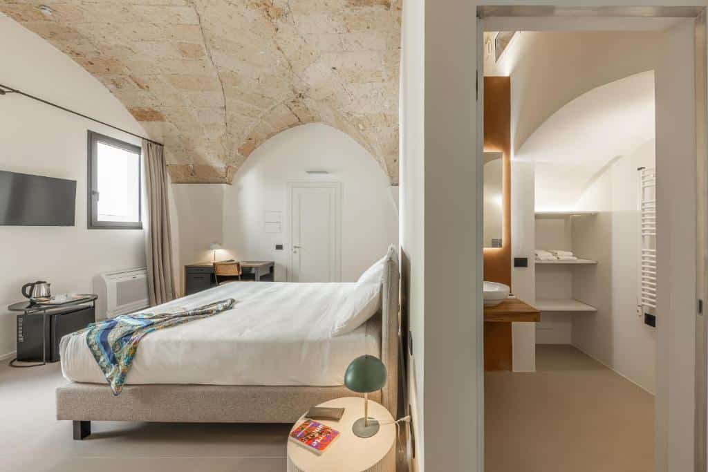 Bed and bathroom at Arco Vecchio Urban Suite. Why Lecce Is Southern Italy's Most Underrated Travel Destination