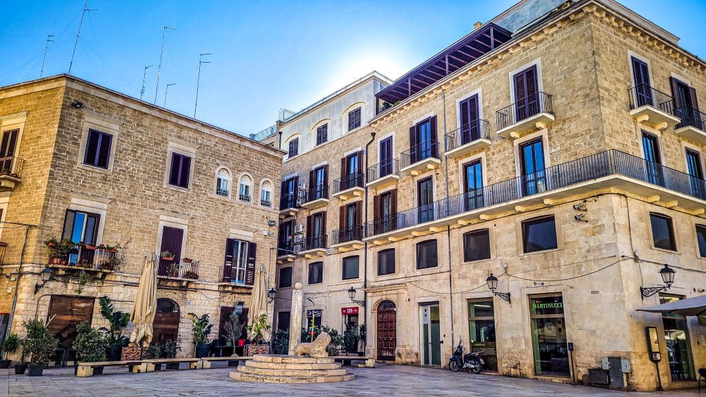 Stone buildings at a piazza in the old city. Bari Travel Guide: Discover Hidden Gems in Puglia’s Capital. In the worlds jungle travel blog.