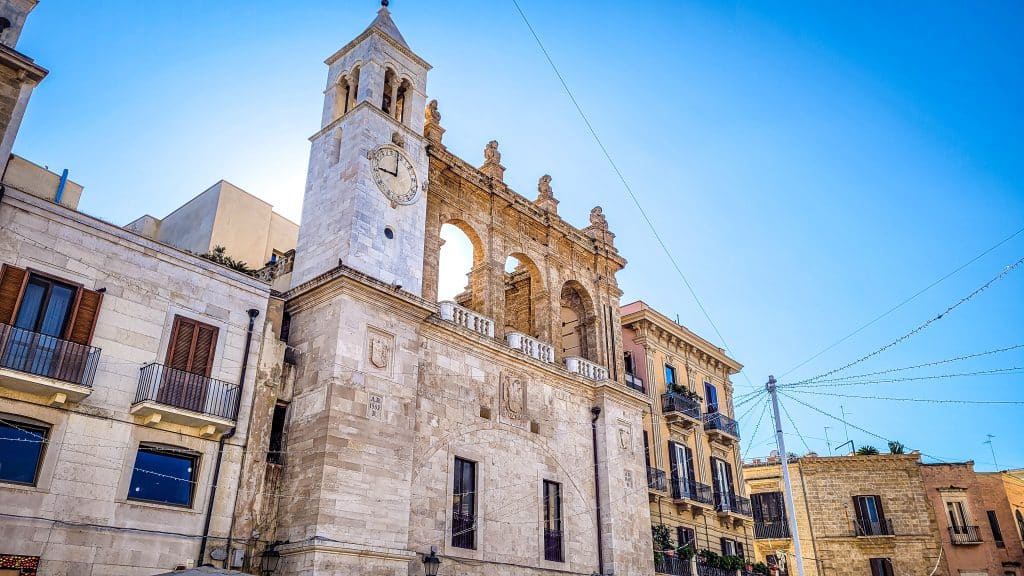 The unique architecture and clock tower of Palazzo del Sedile. Bari Travel Guide: Discover Hidden Gems in Puglia’s Capital. In the worlds jungle travel blog.