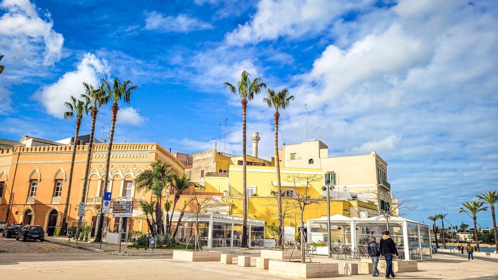 Palmtrees and colourful buildings at the promenade. Brindisi Travel Guide: Everything You Need to Know Before You Visit