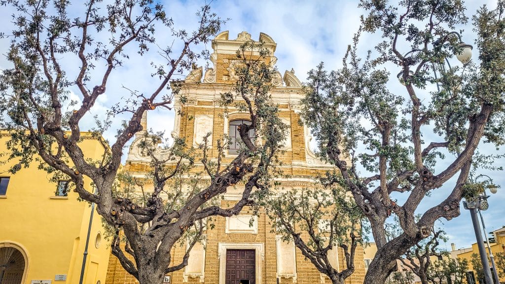Trees and exterior architecture of the Church of Saint Theresa. Brindisi Travel Guide: Everything You Need to Know Before You Visit