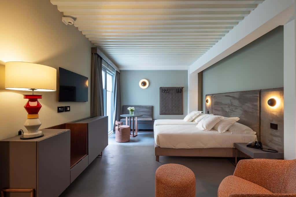 Bedroom at VIS Urban Suites & Spa - Boutique Hotel. Bari Travel Guide: Discover Hidden Gems in Puglia’s Capital. In the worlds jungle travel blog.